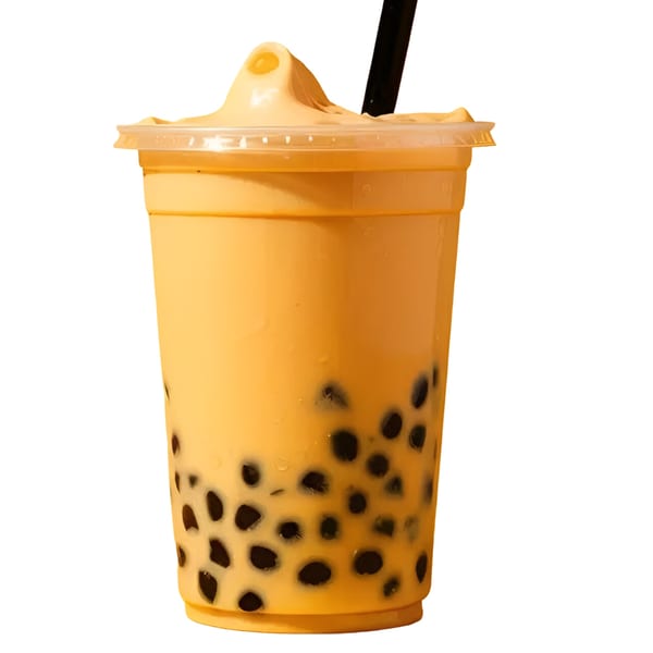 A plastic cup of yellow bubble tea with dark tapioca pearls and a black straw.