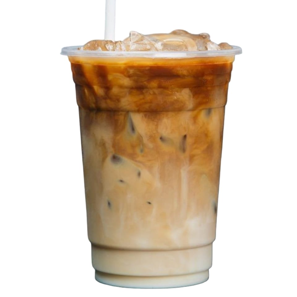 Iced coffee with milk and ice in a clear plastic cup with a straw.